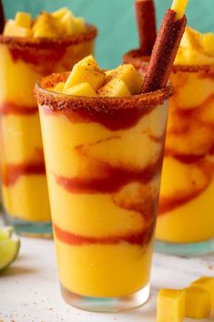 two glasses filled with fruit and cinnamon