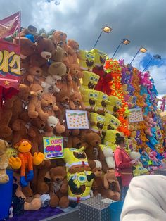 there are many stuffed animals on display at the fair, including teddy bears and other toys