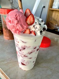 two scoops of ice cream with strawberries on top