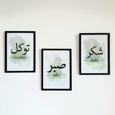 three framed art pieces hang on the wall