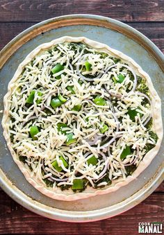 a pizza sitting on top of a pan covered in cheese and veggie toppings