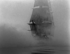 an old photo of a ship in the fog