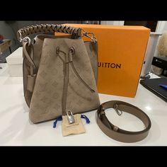 Retails For 4650usd + Tax In Excellent Practically New Condition. No Scratches On Hardware One Little Scuff On The Leather On The Silver Hardware (Shown In Photo). Barely Noticeable Comes With Strap Dust Bag And Box Made In France Ah4149 Beautiful Galet Gray Color 9.8l X 9.8h X 7.9w Please Ask All Questions And Any Additional Photos Prior To Purchase. Have It Posted For Less On Lv Fb Group Designer Monogram Canvas Bucket Satchel Bag, Designer Monogram Canvas Bucket Bag With Detachable Strap, Designer Travel Bucket Bag With Branded Hardware, Designer Monogram Canvas Bucket Bag With Adjustable Strap, Everyday Luxury Monogram Canvas Bucket Bag, Luxury Monogram Canvas Crossbody Bucket Bag, Designer Brown Bucket Bag With Branded Hardware, Designer Brown Bucket Bag, Luxury Beige Bucket Bag