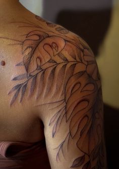 a woman with a tattoo on her shoulder