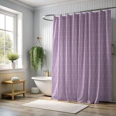 a bathroom with a bathtub, sink and shower curtain in purple color on the wall