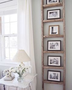 an old ladder is used as a shelf for pictures