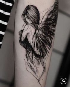 a black and white photo of a woman with wings on her arm, done by tattoo artist