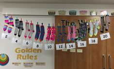 there are many pairs of socks hanging from the line on the wall next to each other