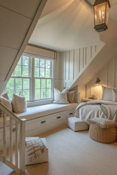 a bed sitting under a window in a bedroom next to a white dresser and chair