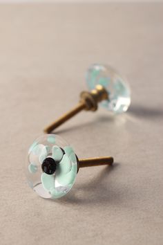 two glass door knobs with flowers on them