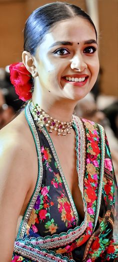 a woman with makeup on her face smiling