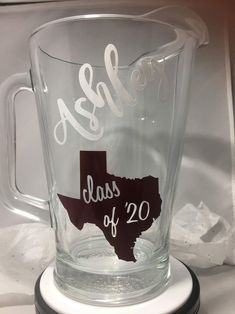 a glass mug with the word class of 20 etched into it