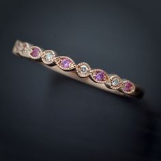 14kt wedding stackable band in white yellow or pink gold made to order. The band consists of 5 diamonds, 1.2mm total weight .03ct prong set H-VS 6 Natural Pink Sapphires 1.15mm The band dimensions are 2.13mm width by 1.5 height. This is a perfect gift or as a wedding band. or just an everyday stackable ring. Buyers can request customization to alternate diamonds and different stones. Pink Diamond Stackable Rings For Anniversary, Pink Diamond Stackable Rings With Prong Setting, Pink Stackable Diamond Ring, Pink Bezel Set Stackable Rings For Anniversary, Band With Diamonds, Ring Stacks, Birthstone Rings, Pink Stones, Stackable Bands