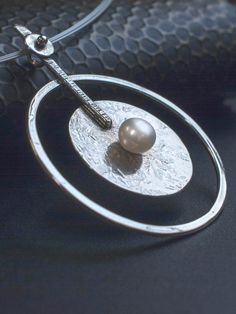 This is a large Pendant crafted on fine Silver beautifully balanced with a genuine cultured Pearl in the center. Ideal bridal necklace. Available on Diapiro' eshop Price 126 euros and free experss shipping. #silver_necklace #silver_jewelry _bridal_necklace #wedding_jewelry #women's_style #women's_fashion #silver_pendant #statement_necklace #geometric_pendant #Pearl #woman's_accesories Metal Pearl Charm Necklace, Metal Pearl Drop Necklace, Modern Pearl Pendant Necklace, Modern Pearl Drop Pendant Necklace, Modern Round Pearl Drop Jewelry, Modern Silver Jewelry With Pearl Drop, White Round Pearl Necklace, Modern Sterling Silver Jewelry With Pearl Pendant, Modern Silver Pearl Necklace With Pearl Drop