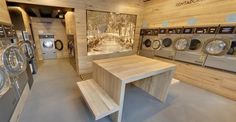 a laundry room with washers and dryer machines in it's display area