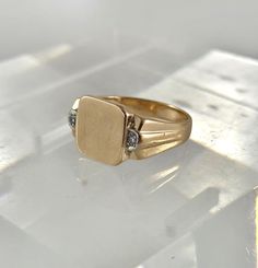 Art Deco 10Kt men's soft square signet ring  with small Diamonds on shoulders size 8.25 SKU-1982 A classic signet ring with a soft square face, and grooved and tapered shoulders. The ring has 2 small single cut accent Diamonds, one on each shoulder framing the ring nicely. This men's ring is ready to be personalized with your initial(s) by the goldsmith or engraver of your choice. D E T A I L S : Measures     :   Ring size 8.25 Diamonds    :   2 single cut approx. combined weight .03 Carat Weigh Vintage Rectangular Diamond Ring For Gift, Vintage Rectangular Diamond Ring Gift, Classic Rectangular Diamond Ring With Polished Finish, Classic Everyday Engraved Rectangular Ring, Classic Rectangular Engraved Ring For Everyday, Heirloom Gold Rectangular Diamond Ring, Classic Rectangular Diamond Ring, Classic 14k Stamped Diamond Ring, Classic Rectangular Signet Ring For Formal Occasions