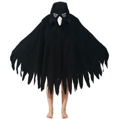 a child wearing a black cape with white teeth and eyes on it's face