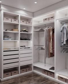 a walk in closet filled with lots of white drawers and clothes hanging on shelves next to each other