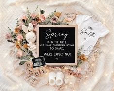 a baby announcement is displayed on a blanket with flowers and other things to write in it