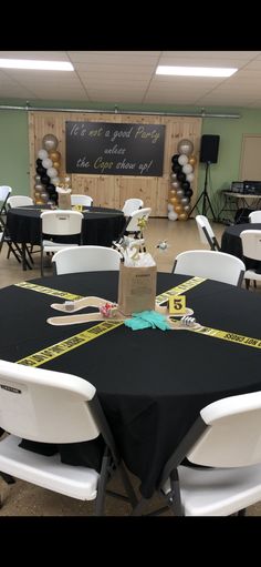 there is a black and white table cloth on top of the tables in this room