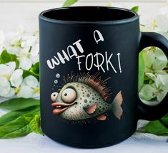 a black coffee mug with an image of a puffer fish on it and the words, what a fork