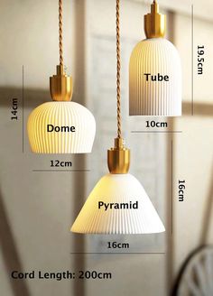 three white lamps hanging from the ceiling with measurements