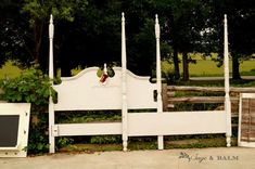 a white bed sitting next to a wooden fence