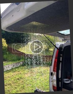 the back end of a van with rain coming from it