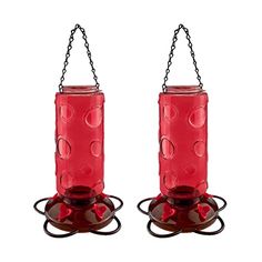 two red glass bird feeders with chains hanging from the sides and one has a chain attached to it