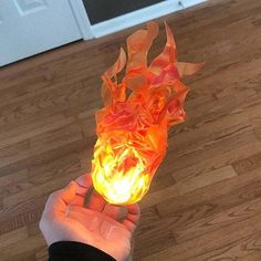 a person is holding a fireball in their hand