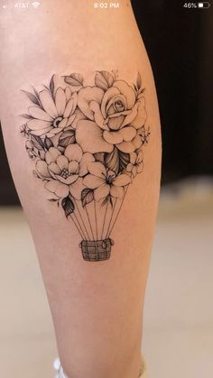 a woman's leg with flowers and a basket on it, in the shape of a balloon