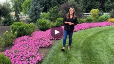 a woman standing in the middle of a flower garden