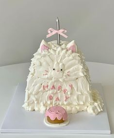 a cake shaped like a cat with pink icing