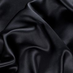 Presenting a quality Premium Black Stretch Silk Charmeuse made especially for Mood. Medium weight with an exquisite drape, this lustrous material is made that much more versatile given its added crosswise stretch. The ideal fabric for classic gowns, dresses, blouses and lingerie, silk charmeuse can also be used for superior linings. Available in 95+ attractive shades. 

Note: Dye lots are subject to change up to 10% in either direction. Ordering swatches is HIGHLY recommended for these products. Tux Dress, Bed Hair, Silk Bedding Set, Silk Sheets, Silk Sleep Mask, Dress Colors, Silk Set, Silk Bedding, Mood Fabrics