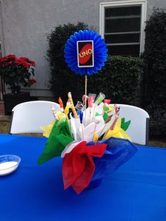 a blue table topped with colorful paper flowers