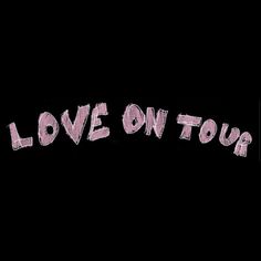 the words love on tour written in pink ink