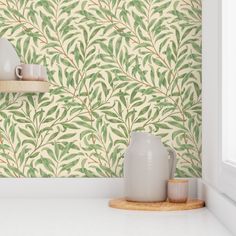 a kitchen counter with two vases on it and a wallpaper pattern behind them