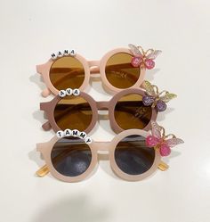 Premium adorable Butterfly personalized name sunglasses for girls. Fit best on your child ages 2-5 If you would like to customize with a name(letters), please enter personalization details( on personalization box). The maximum of 12 letters for each sunglasses. If you would like without name (letter) please select without letter and let me know the color on personalization box or message me. Sunglasses are made with ultraviolet-proof with UV400 lenses optical attribute and lightweight . Lens Width: 50 mm Lens Height:52mm Total width:132mm Bridge width:10 mm Leg length :125 mm All sunglasses come with modern beautiful white leather case. Please see the images. Personalized sunglasses made to order. Perfect for a vacation , beach, birthday gift or party, spring , summer , and photoshoot  🛑 Sunglasses For Girls, Girls Fit, Personalized Sunglasses, Beach Birthday, Name Letters, Girl With Sunglasses, Vacation Beach, Colorful Butterflies, Daughter Love