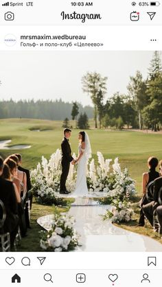 a bride and groom standing at the end of their wedding ceremony in front of a golf course