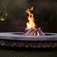 a fire pit with logs burning in it