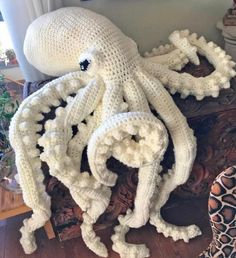 an octopus made out of yarn sitting on top of a table