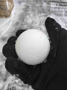 a person holding a snowball in their hand