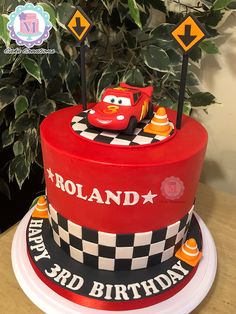 a red and black birthday cake with cars on it