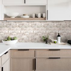 a kitchen counter with cups and bowls on it