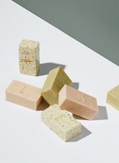 five different types of soaps on a white surface