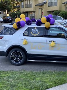 a white car with purple and yellow decorations on top