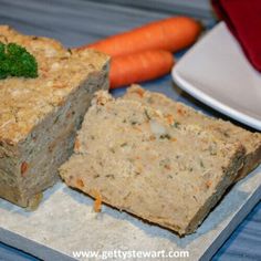 there are carrots, broccoli and meatloaf on the table next to each other