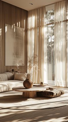 a living room filled with lots of furniture next to large window covered in sheer curtains