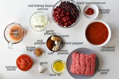 an assortment of ingredients are displayed on a white table top, including meats and sauces