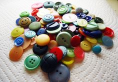 a pile of different colored buttons sitting on top of a white surface with the words, transfiguration hpc midsummerer 2011